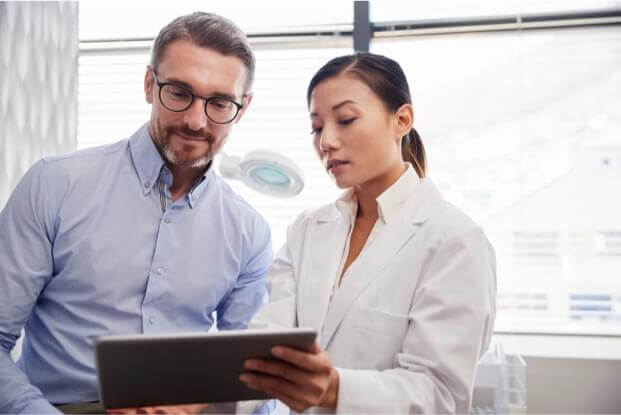 man and doctor looking at chart